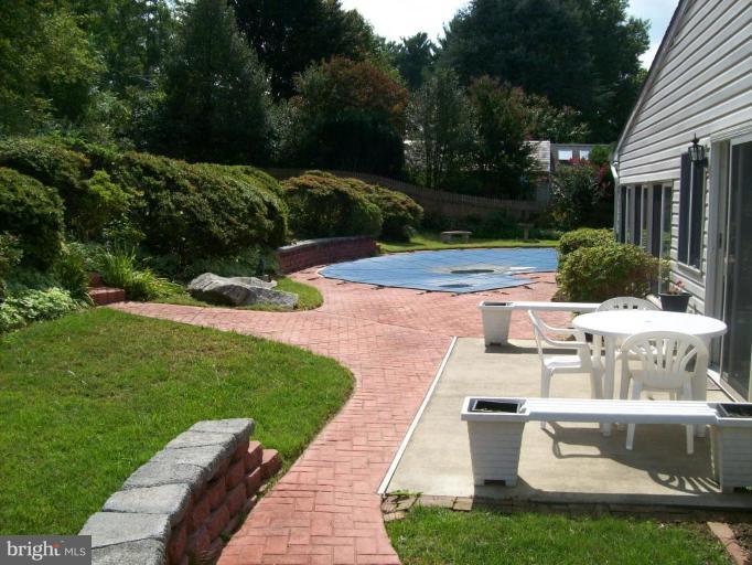 7911 Ruxway Road Towson, MD 21204 - Photo 4 of 9 a view of backyard with swimming pool and outdoor seating