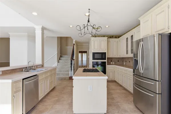 a kitchen with stainless steel appliances a sink and a refrigerator