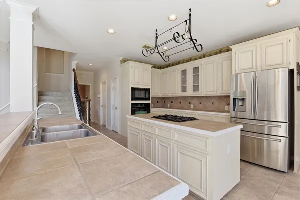 a large white kitchen with a large window
