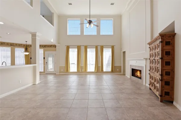 a view of an empty room with a fireplace and a window