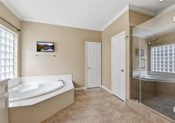 a bathroom with a shower and a glass door