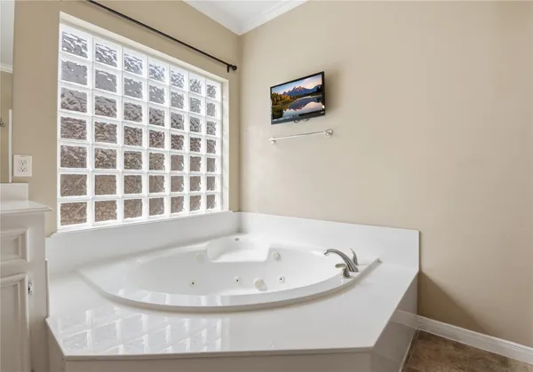 a view of a big room with windows and chandelier fan