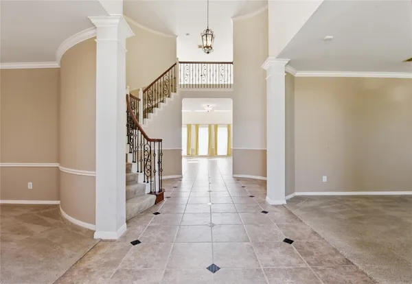 a view of a hallway with entryway dining space and stairs