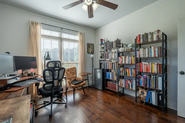 a view of a workspace with furniture and a bookshelf