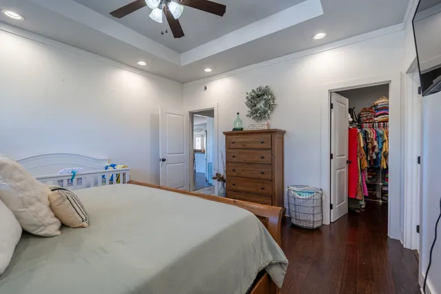 a bedroom with a bed and a chandelier