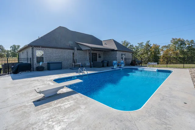 a view of a house with swimming pool and porch