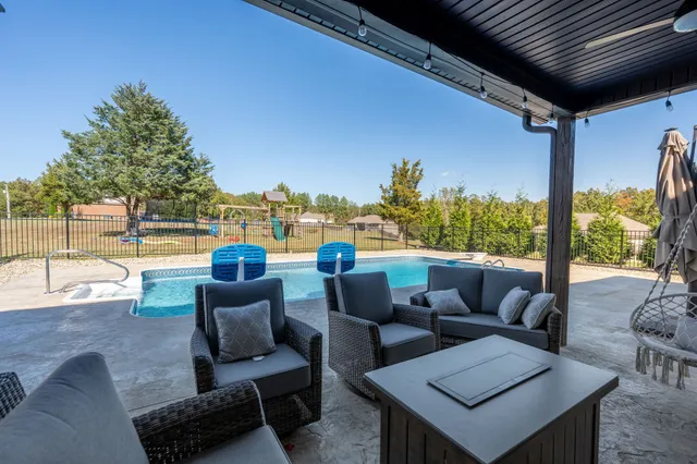 a balcony with furniture and a floor to ceiling window