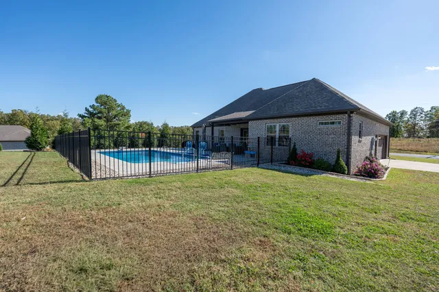 a view of a house with backyard and porch