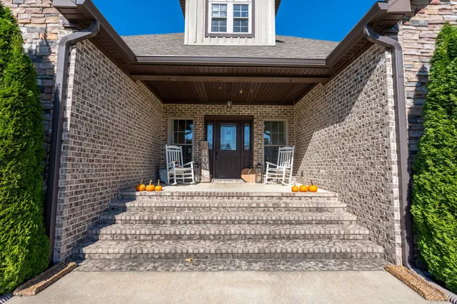 a front view of a house with a garden and plants