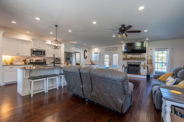 a living room with furniture a flat screen tv and a fireplace