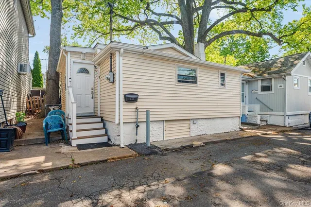 a view of a house with a yard and tree s