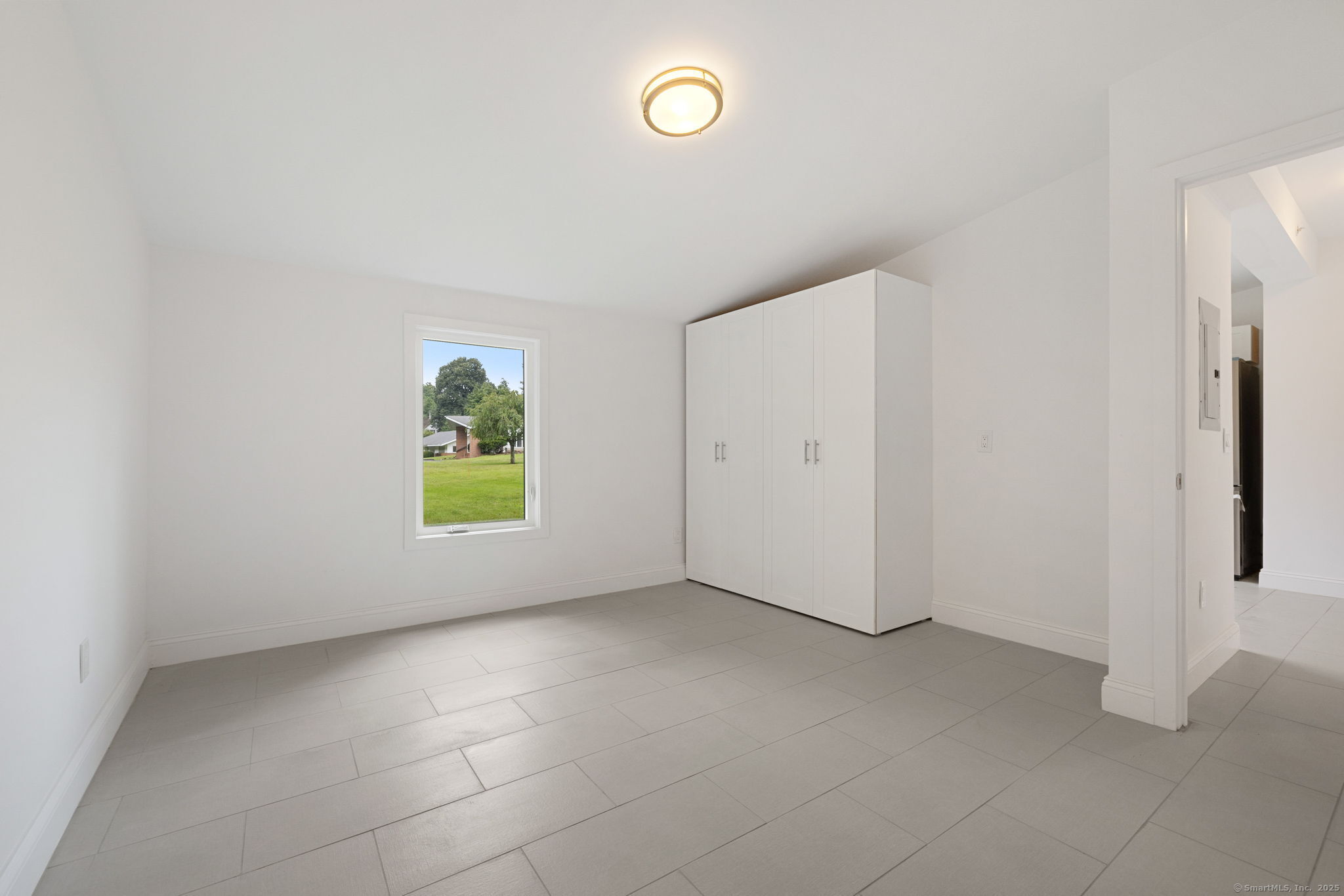 529 Danbury Road, Unit C Wilton, CT 06897 - Photo 12 of 21 an empty room with windows and closet