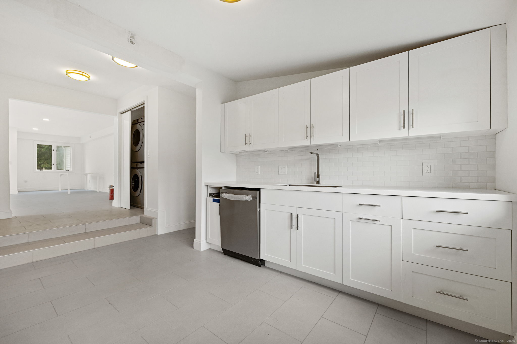 529 Danbury Road, Unit C Wilton, CT 06897 - Photo 2 of 21 a kitchen with white cabinets and white appliances