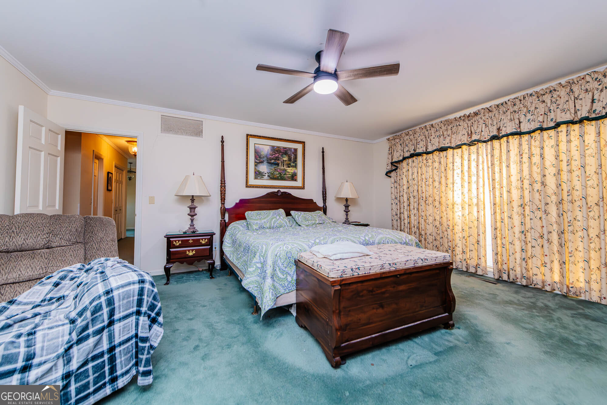 5207 Forest Lake Road Eastman, GA 31023 - Photo 23 of 56 a bedroom with a bed a window and a chandelier