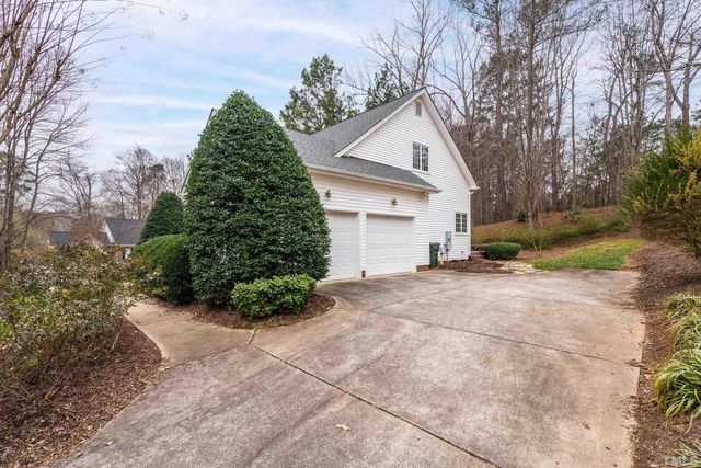 a view of a house with a yard and garage