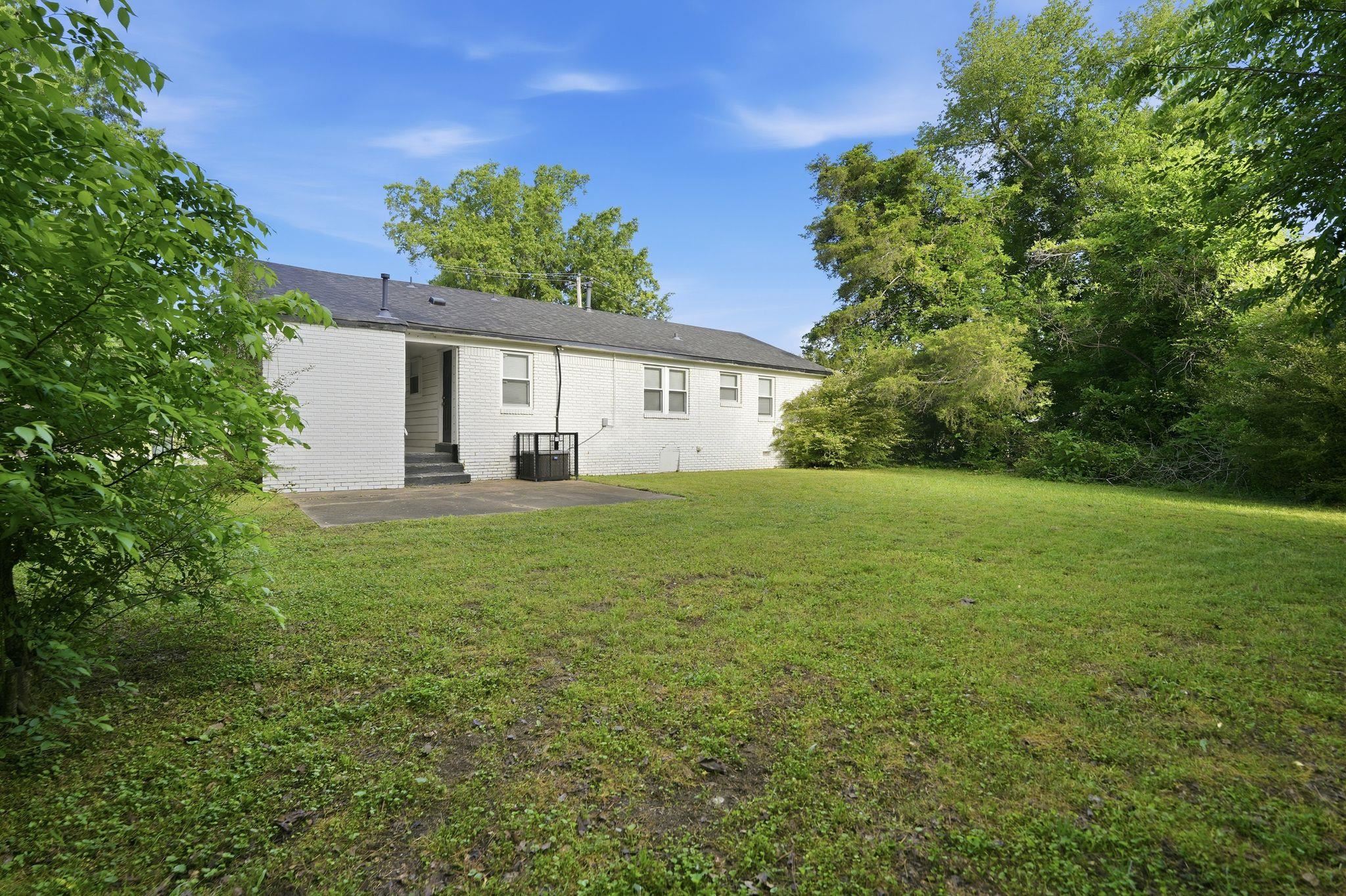 4686 Gill Road Memphis, TN 38109 - Photo 6 of 32 Expansive green lawn with mature trees bordering the property