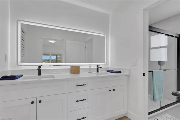 a bathroom with a double vanity sink mirror and