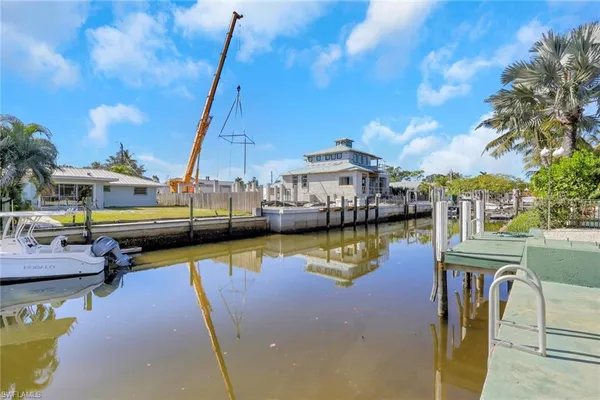 a view of a lake with a deck and dining table