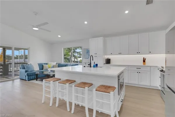 a kitchen with granite countertop cabinets and chairs
