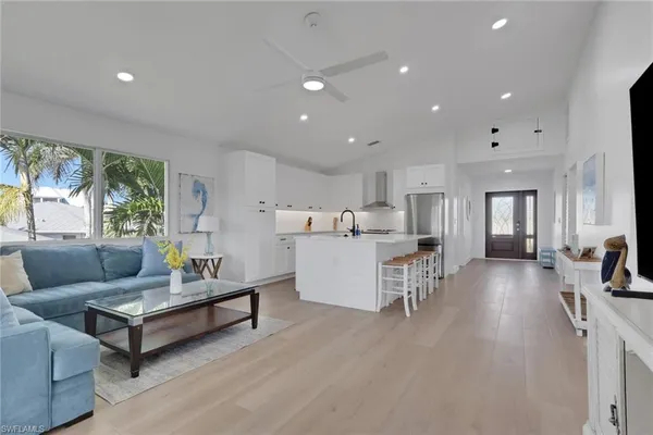 a living room with furniture and a wooden floor