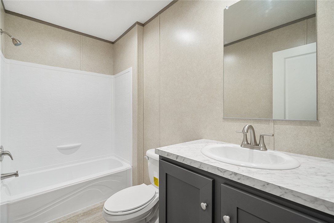 419 Austin Drive Anderson, SC 29624 - Photo 26 of 36 This bright bathroom features a spacious tub and shower combination with a single vanity and mirror.