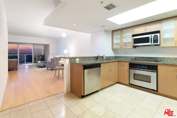 a kitchen with stainless steel appliances granite countertop a stove and a sink