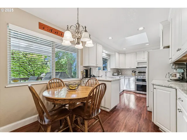 a view of a dining room with furniture large window and wooden floor
