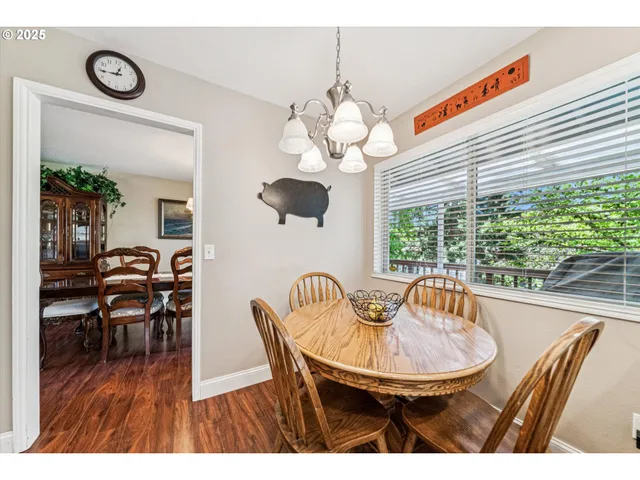 a dining room with furniture a window and wooden floor