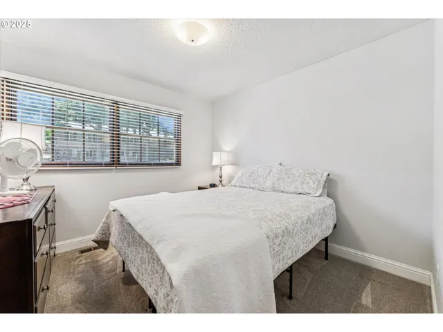 a bedroom with a bed and a table