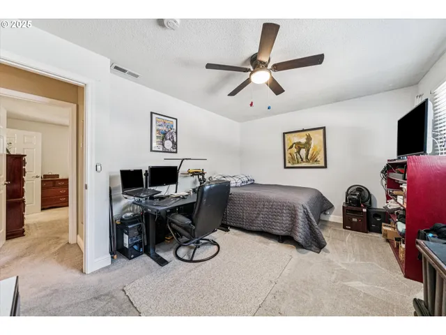 a bedroom with a bed and a desk