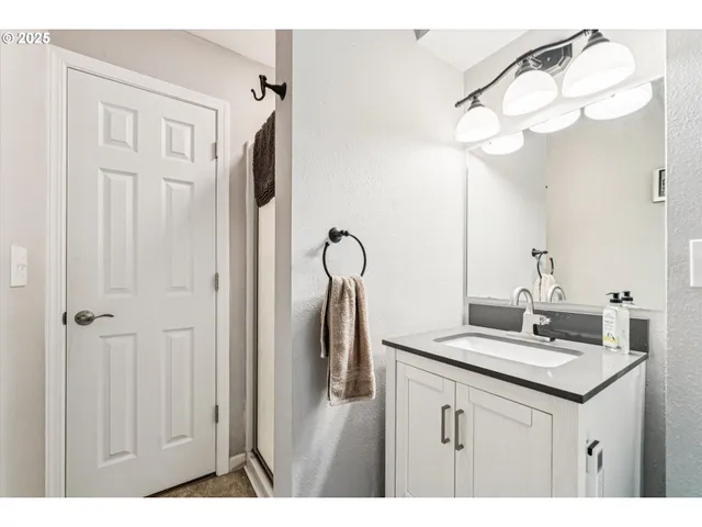 a bathroom with a sink vanity and a mirror