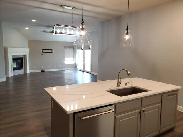 a kitchen with a sink a counter space and cabinets