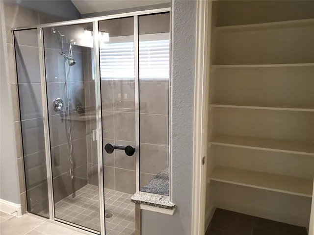 a bathroom with a glass shower door