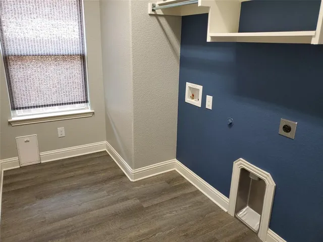 a view of a livingroom with wooden floor and a window