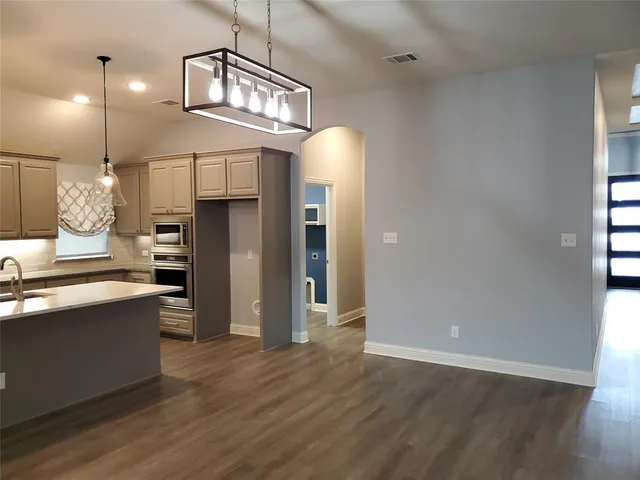 a view of a kitchen cabinets and wooden floor