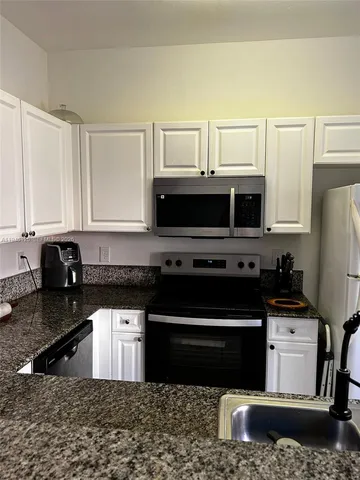 a view of walk in closet with clothes