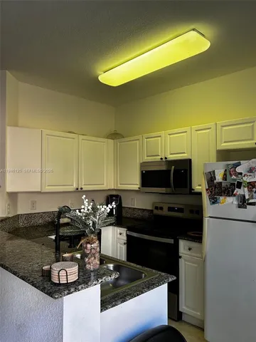 a living room with a bed furniture and a wooden floor