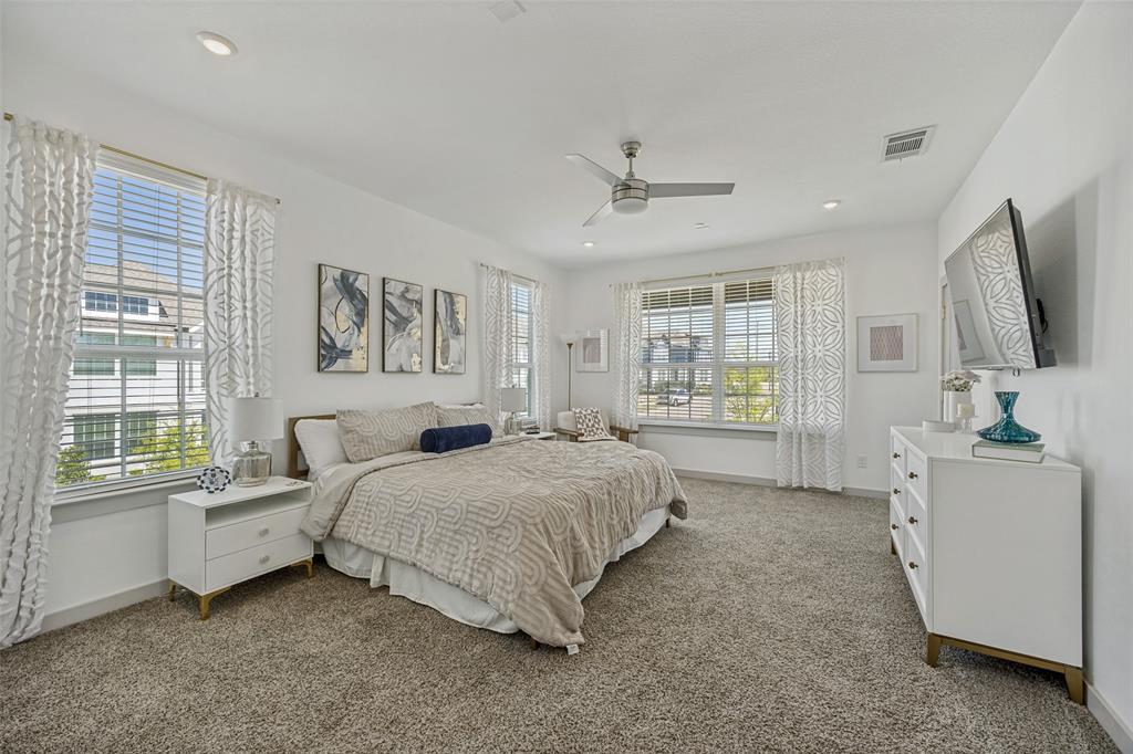 1650 Jessica Lane Allen, TX 75002 - Photo 18 of 25 a spacious bedroom with a large bed and a flat tv screen on dresser