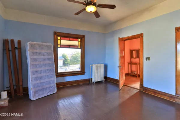 an empty room with closet and wooden floor