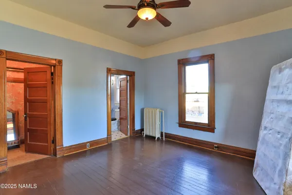 a view of room with window and wooden floor