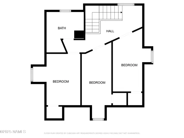 a view of an empty room with cabinet and a window