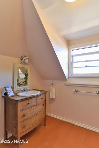 a kitchen with stainless steel appliances a cabinets and a wooden floor