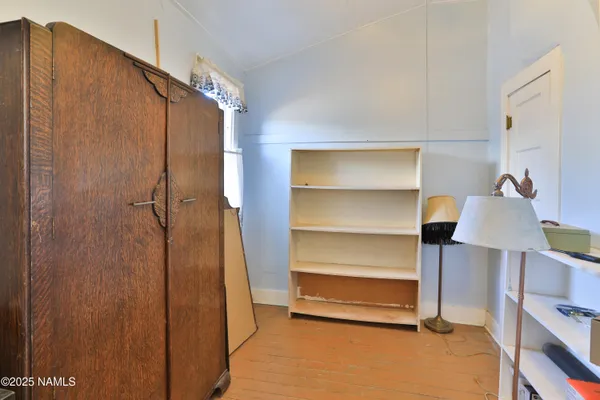 a view of hallway with wooden floor and stairs