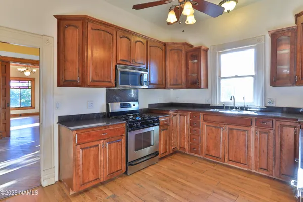 a kitchen with stainless steel appliances granite countertop a sink stove and cabinets
