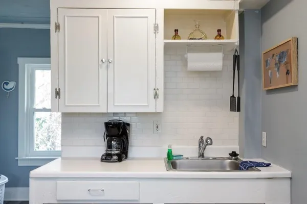 a living room with a wooden floor and next to a window