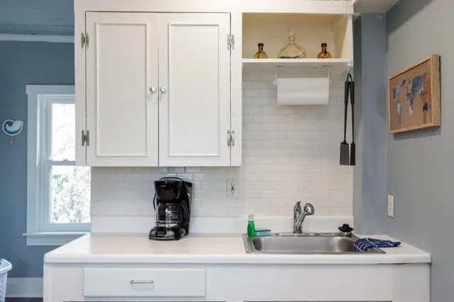 a living room with a wooden floor and next to a window