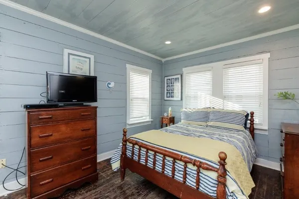 a bedroom with a bed and a flat screen tv