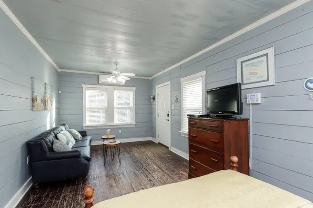 a living room with furniture and a flat screen tv
