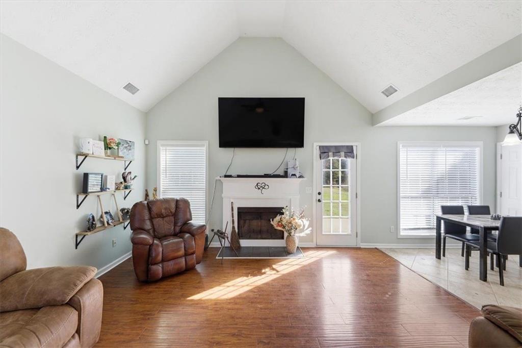 493 Youth Jersey Road Covington, GA 30014 - Photo 12 of 52 a living room with furniture a flat screen tv and a fireplace