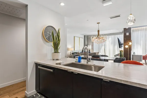 a kitchen with sink and a mirror